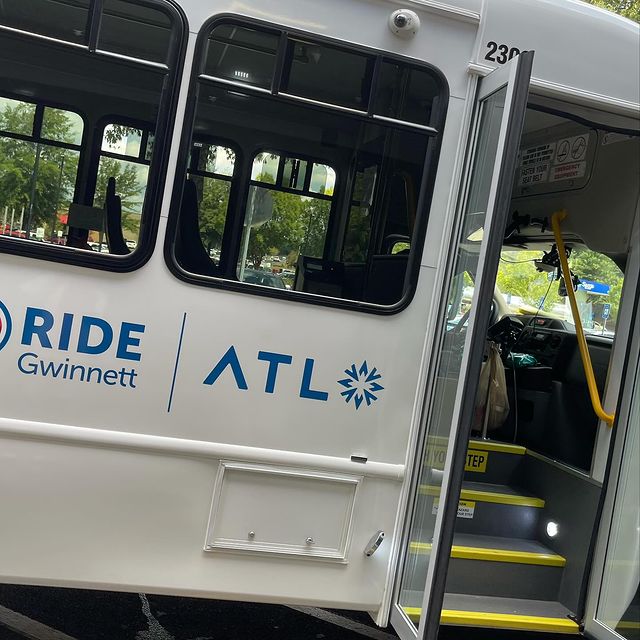 Gwinnett County's Ride Gwinnett transit service microtransit van opens its doors for boarding passengers.